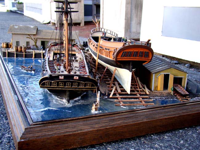 A fabulous and highly detailed scale model diorama circa 1920 of a New England Ship yard circa 1800-1812 making repairs on a 38 Gun American Frigate and a 10 Gun Privateer built circa 1785. — image 5